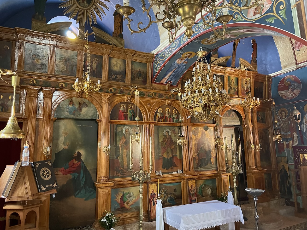 Ornate gilded iconostasis and painted blue ceiling inside the church of Panagia